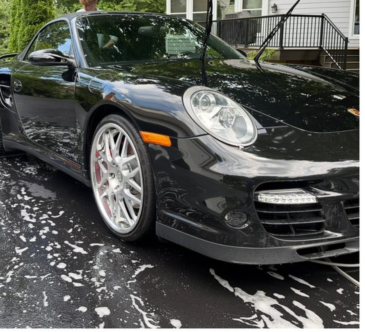 Black Porsche being washed by Brice's Mobile Detailing